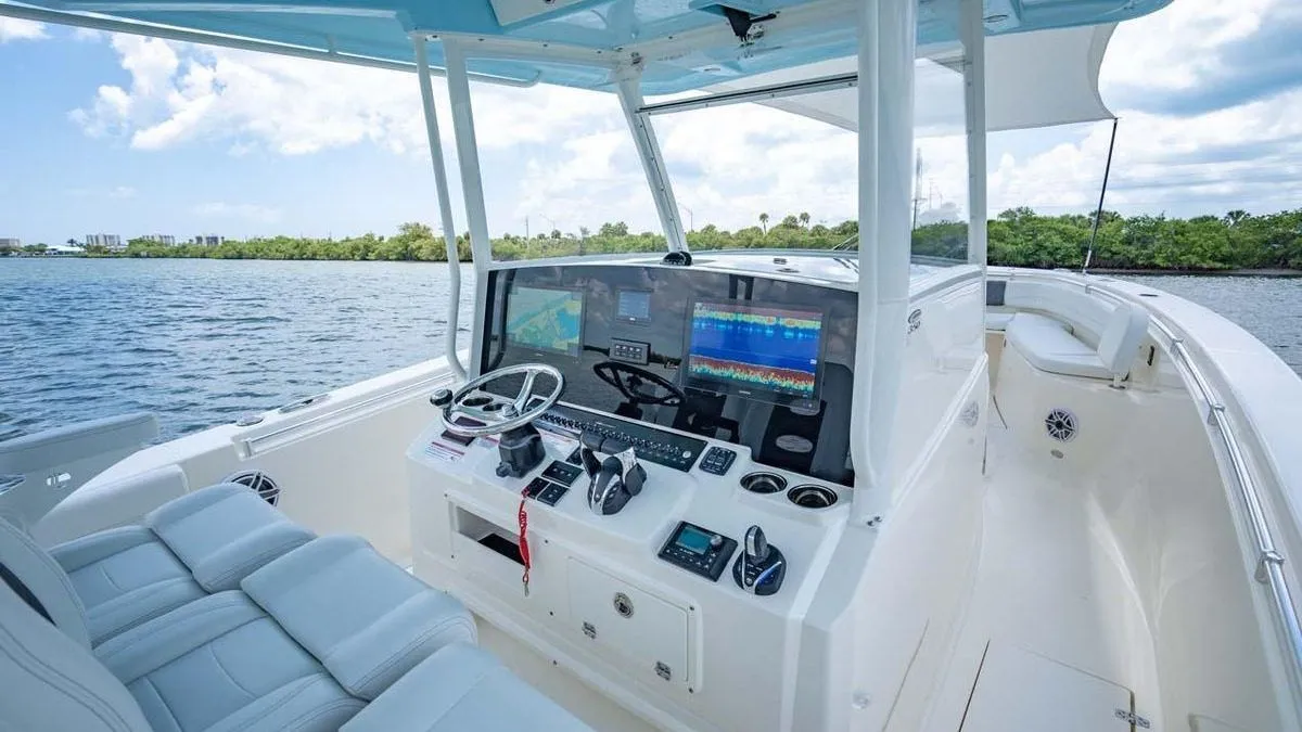 The helm of a centre-console charter boat, twin chartplotters